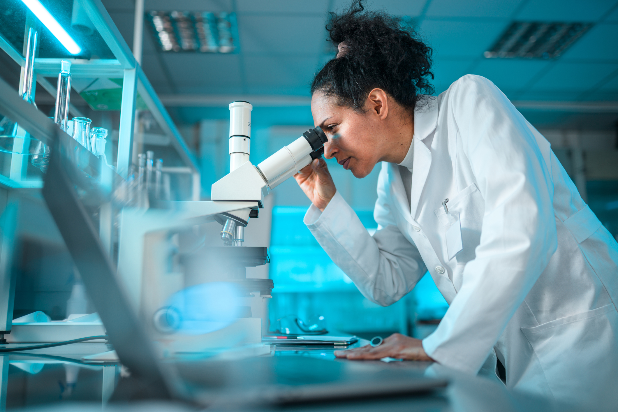Female Pharmacist Looking Through a Microscope Chemical engineer working on detergent formulation design at modern lab.