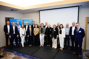 Group of professionals at a detergent industry conference in a modern conference room.